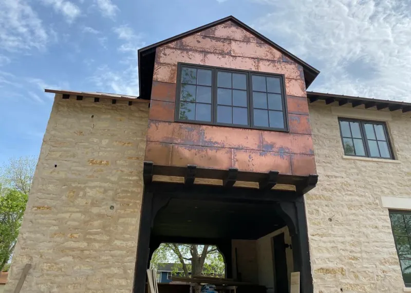 Copper metal panel facade on a stone building for Skylight Installation in Monrovia