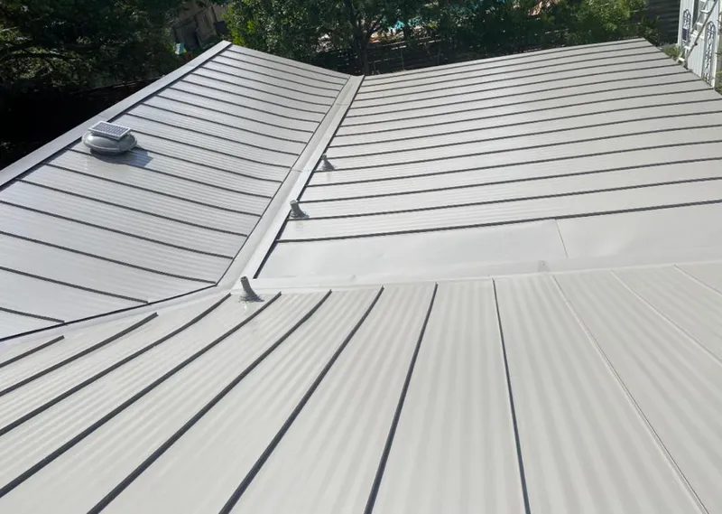 Solar attic fan installed on a metal roof for Roof Ventilation in Monrovia